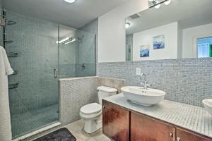 a bathroom with a toilet and a sink and a shower at Nulu Art District Loft Walk to Dtwn Distilleries! in Louisville +18 photos