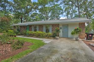 a small brick house with a blue door at Downtown Home with Yard and BBQ - 6 Mi to Downtown! in Beaufort