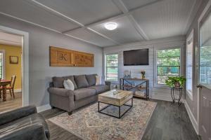 a living room with a couch and a tv at Quaint Home with Deck and Grill - Mins to Lake Fork! in Emory