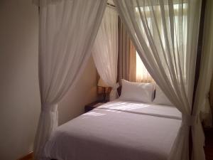 Postel nebo postele na pokoji v ubytování Anh Dao Mekong Hotel