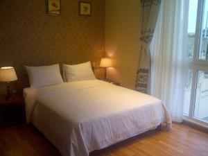 Postel nebo postele na pokoji v ubytování Anh Dao Mekong Hotel