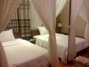 Postel nebo postele na pokoji v ubytování Anh Dao Mekong Hotel