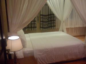 Postel nebo postele na pokoji v ubytování Anh Dao Mekong Hotel