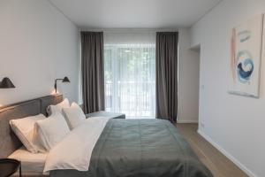 Postel nebo postele na pokoji v ubytování Apartment Hotel Laisve
