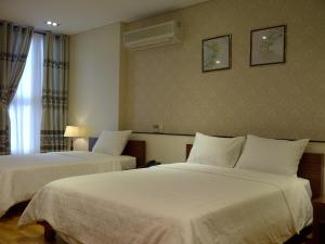 Postel nebo postele na pokoji v ubytování Anh Dao Mekong Hotel