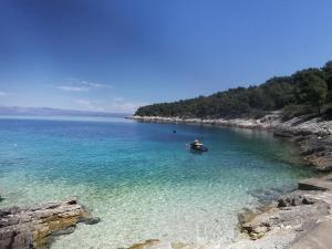 a person in a boat in a body of water at Holiday house Karla in Vela Luka