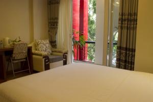 Postel nebo postele na pokoji v ubytování Anh Dao Mekong Hotel