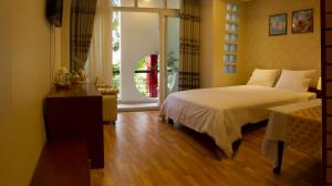 Postel nebo postele na pokoji v ubytování Anh Dao Mekong Hotel