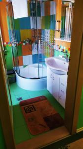 a colorful bathroom with a shower and a sink at Apartmány v Centru in Třeboň
