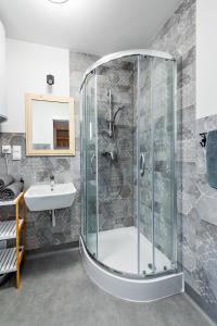 a bathroom with a shower and a sink at Na Klifie Wypoczynek&Spa in Rewal