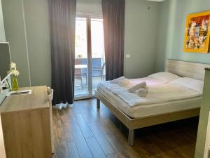 a small bedroom with a bed and a balcony at Iris Studios in Umag