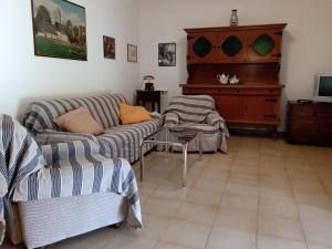 a living room with two couches and a piano at La Fondona in Campagnatico