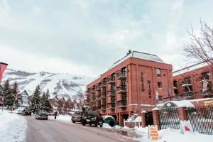 a red brick building on a street with snow on the ground at Shadow Ridge in Park City