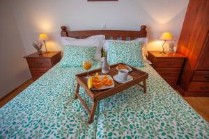 a bed with a tray of oranges on it at Apartment Jerry with private pool in Milna