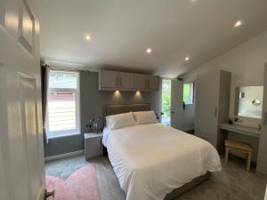 a bedroom with a white bed and a desk at Fox Lodge at Owlet Hideaway - with Hot Tub, Near York in York