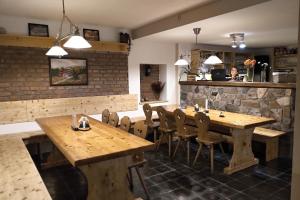 a dining room with wooden tables and chairs at Hotel Alba in Deštné v Orlických horách