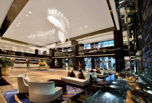 a lobby with couches and chairs in a building at Howard Johnson Hi - Tech Plaza Chengdu in Chengdu