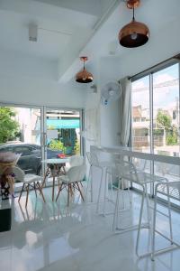 a dining room with a glass table and chairs at Baankanjana in Hat Yai