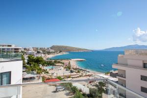 a view of the beach from the balcony of a building at Harbour Hotel in Sarandë