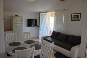 salon ze stołem i kanapą w obiekcie Apartments Tomas w mieście Betina