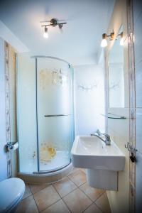 a bathroom with a glass shower and a sink at Pokoje gościnne Jolka in Łeba +107 photos