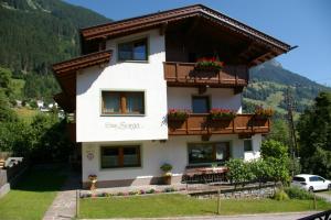 a house in the mountains with flowers on the balconies at Haus Sonja in Finkenberg