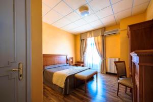 Postel nebo postele na pokoji v ubytování Hotel Maderno