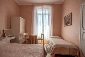 Postel nebo postele na pokoji v ubytování Hotel Maderno