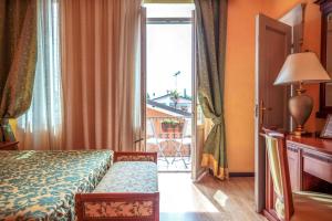 Postel nebo postele na pokoji v ubytování Hotel Maderno