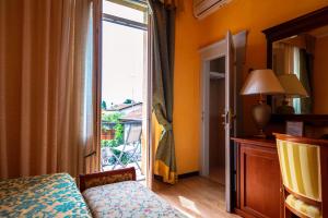 Postel nebo postele na pokoji v ubytování Hotel Maderno