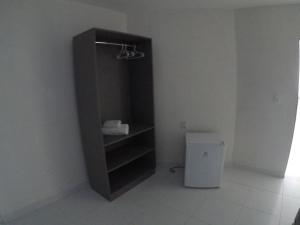 a black cabinet in a room with a toilet at Pousada Tambaú in João Pessoa