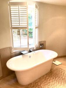 a white bath tub in a bathroom with a window at College View in Cheltenham