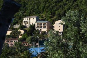 a group of buildings in a town with a mountain at Hôtel Casa Mea in Bastia