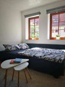a bedroom with a bed, desk, chair and window at Daheym FEWO 3 in Erfurt