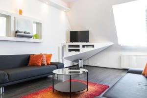 a living room with a couch and a table at Helena apartment with view on St. Stephan's Basilica in Budapest