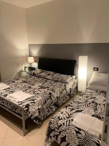 a bedroom with two beds and a lamp at Lucky House in La Spezia