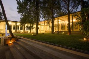 an exterior view of a building with trees and lights at Clio Bolgoda in Piliyandala +14 photos