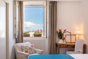 a bedroom with a bed and a window and a desk at Promenade Room Split **** in Split