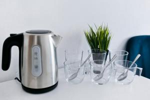 a coffee pot and glasses on a table at Przyjaciół 13 in Mielno
