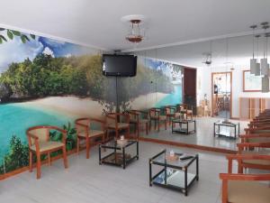 a room with a mural of a beach on the wall at Hotel Villa in Isla