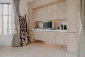 a living room with a tv and a shelf at ZEN b&b in Dordrecht