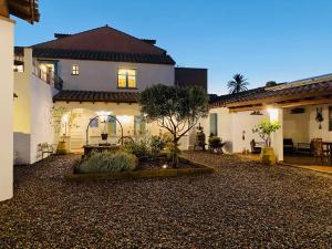 a house with a courtyard in front of it at Centu Concas in Muravera