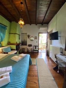 a bedroom with a large blue bed in a room at Petrino in Palaios Panteleimon