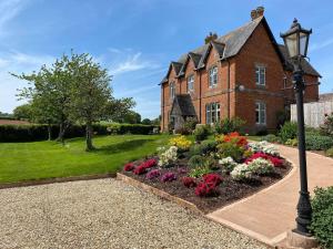 un jardín frente a una casa con luz de la calle en Newcourt Barton, en Cullompton