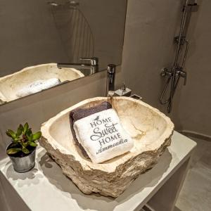 a bathroom sink with a rock sink at Home Sweet Home in Ammoudia
