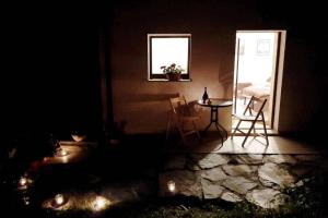 a dark room with a table and chairs and a window at La Maison de Joanna in Châtillon