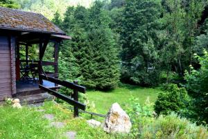 a cabin with a porch in a field with trees at Sommerhaus Bella Vita in Bad Schandau
