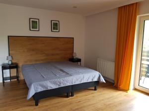 Postel nebo postele na pokoji v ubytování POD BRZEGIEM