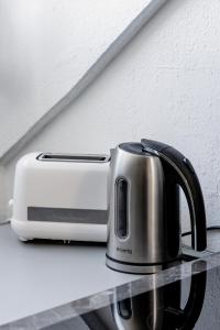 a toaster sitting on a counter next to a toaster at Comfort Stay Basel Airport 3B46 in Saint-Louis