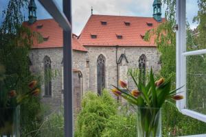 an image of a church seen through a window at Monastery Garden Prague in Prague